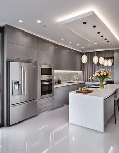 a modern kitchen with stainless steel appliances and white counter tops, along with an island