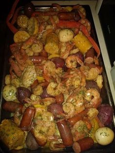 a pan filled with shrimp and potatoes on top of a stove