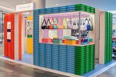 a colorful display case filled with bags and purses