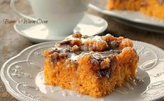 a piece of cake sitting on top of a white plate next to a cup and saucer