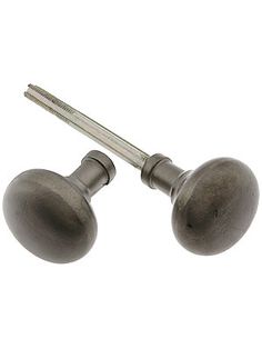 two metal knobs and a screw on a white background