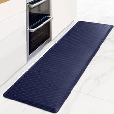 a blue kitchen mat with an oven in the background