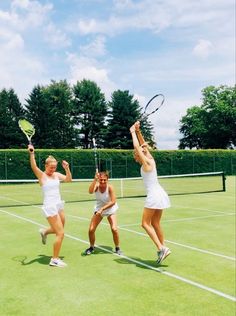 three women are playing tennis on the court