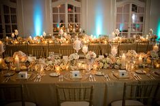 the tables are set with candles, flowers and place settings for an elegant wedding reception