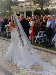 a bride and groom walking down the aisle