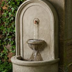 a water fountain sitting next to a building