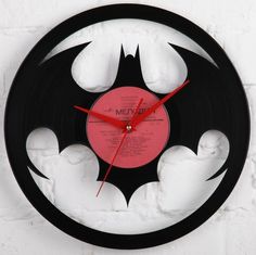 a clock made out of an old vinyl record with the bat symbol on it's face