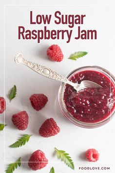 raspberry jam in a jar with fresh raspberries around it and the words low sugar raspberry jam