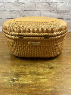 a wicker basket sitting on top of a wooden table