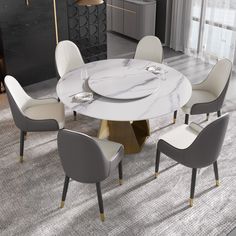 a white marble table with four chairs around it