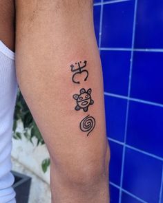 a man with a tattoo on his arm that has an image of a monkey and spirals