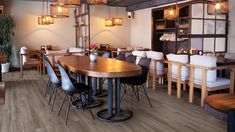 an empty restaurant with wooden tables and chairs