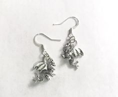 Silver plated hypoallergenic hooks earrings with pewter Dragon charms Includes rubber backs Gift Packaging included Handcrafted Free shipping in USA Made in USA Global site tag (gtag.js) - Google Ads: 645572217 window.dataLayer = window.dataLayer || []; function gtag(){dataLayer.push(arguments);} gtag('js', new Date()); gtag('config', 'AW-645572217'); Gemini Jewelry, Dragon Earrings, Google Ads, Earrings Silver, Gift Packaging, Silver Plate, Silver Earrings, Silver Plated, Made In Usa