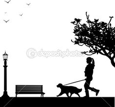 a woman walking her dog on a leash in front of a park bench and lamp post