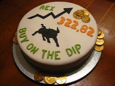 a cake that has been decorated with gold coins and an image of a bull on the dip