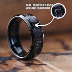 an image of a wedding ring with black and silver inlays on the inside