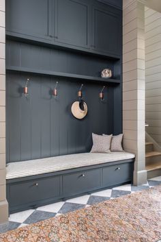 a room that has some shelves on the wall and a bench in front of it