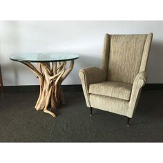 a chair next to a table with a tree trunk design on the top and bottom