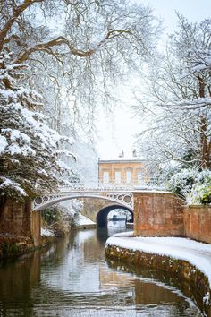 a bridge over a river with snow on the ground