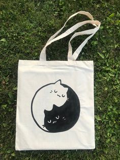 a tote bag with a black and white cat on it