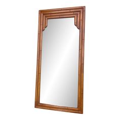 a wooden mirror sitting on top of a white wall with a bamboo frame around it