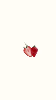 two strawberries sitting on top of each other in front of a white background,