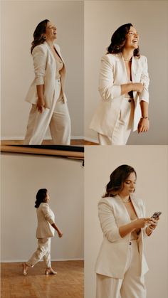 a woman in all white is smiling and looking at her cell phone while standing on the floor