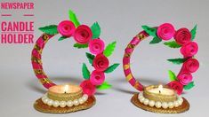 two small candles are decorated with flowers and pearls on the sides, one candle holder is made out of paper