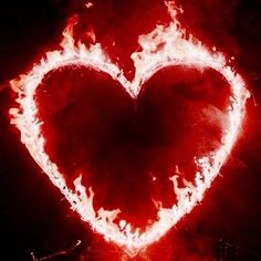 a heart shaped fireball in the middle of a black background with red and white flames