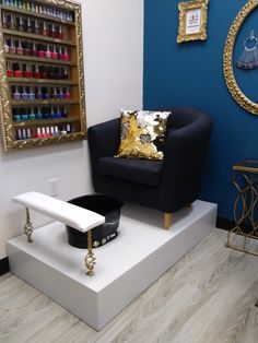 a chair with a gold pillow on it in front of a blue wall