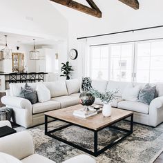 a living room filled with furniture and a fire place in the middle of a room