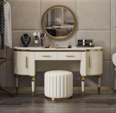 a white vanity with gold accents and a round mirror on the wall next to it