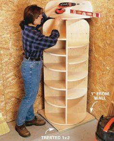 a man is working on a shelf in a room with plywood walls and wood paneling