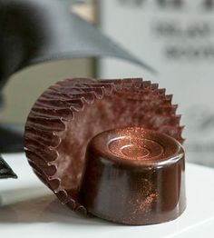 a chocolate cupcake sitting on top of a table