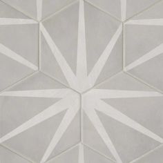 a white and grey geometric tile design