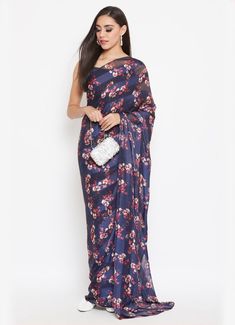 Feel luxurious in this navy blue floral printed satin georgette saree. It comes with a sleeveless lurex silk navy crop top which has a sweetheart neck. This saree is perfect for all festive occasions and is absolutely hassle free. Navy Crop Top, Georgette Sarees, Floral Blouse, Sarees Online, Satin, Floral Prints