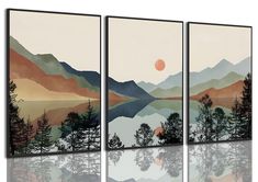 three canvases with mountains and trees on them, one is reflecting in the water