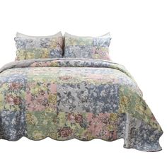 an image of a bed with flowers on the comforter and pillow cases in pastel colors