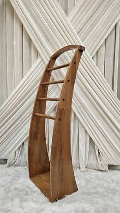 a wooden boat shaped sculpture sitting on top of a white rug