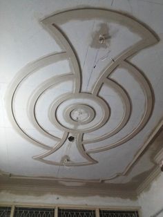 the ceiling is covered in white paint and has circular designs on it's sides