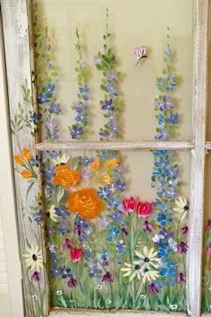 an old window with flowers painted on it