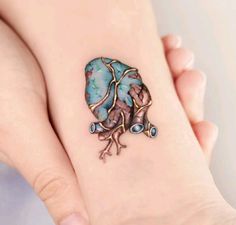 a woman's foot with a tattoo on it