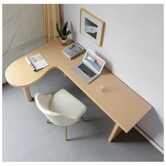 an office desk with a laptop on it