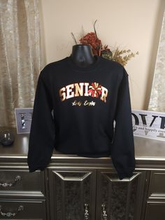 The Senior Cheer sweatshirt is custom made with colors that best represent your athlete's team. The design cost includes two colors. Personalization is offered (additional fees apply, see the options available for more details). If you have any questions, please don't hesitate to contact us. *Colors may vary but we will do our best to match the team colors as best as possible. A photo really helps. Black School Spirit Sweatshirt For Sports, Black Long Sleeve Sweatshirt For School Spirit, Black Team Spirit Sweatshirt For College, Black School Spirit Sweatshirt For Sports Events, Customizable Varsity Tops For Streetwear, Black Sweatshirt For School Spirit Streetwear, Black Sweatshirt For Streetwear With School Spirit, Black Varsity Sweatshirt With Team Name, Black Crew Neck Hoodie For School Spirit