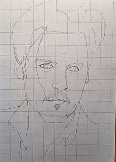 a drawing of a man's face is shown on a piece of graph paper