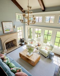 a living room filled with furniture and a fire place in the middle of a room