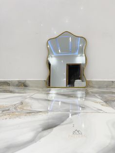 a white marble counter top with a mirror on it