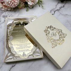 an open box with a wedding card inside