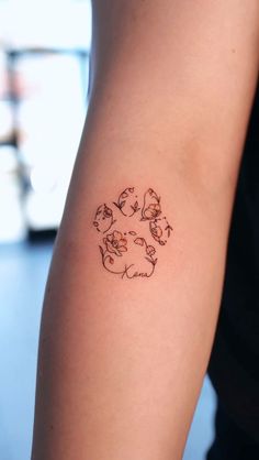 a person with a tattoo on their arm that has cats and dogs in the center