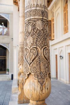 an intricately carved column in the middle of a courtyard